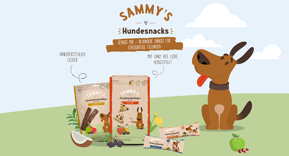 Hund sitzt auf Wiese und freut sich auf einen leckeren Sammy's Snack